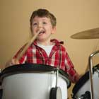 child enjoying drum lessons